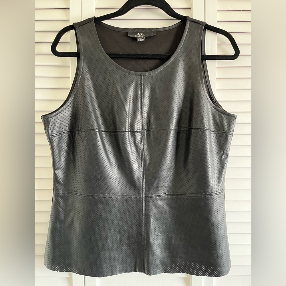 Black pleather top or vest, worn alone or with an article under it. Worn as vest